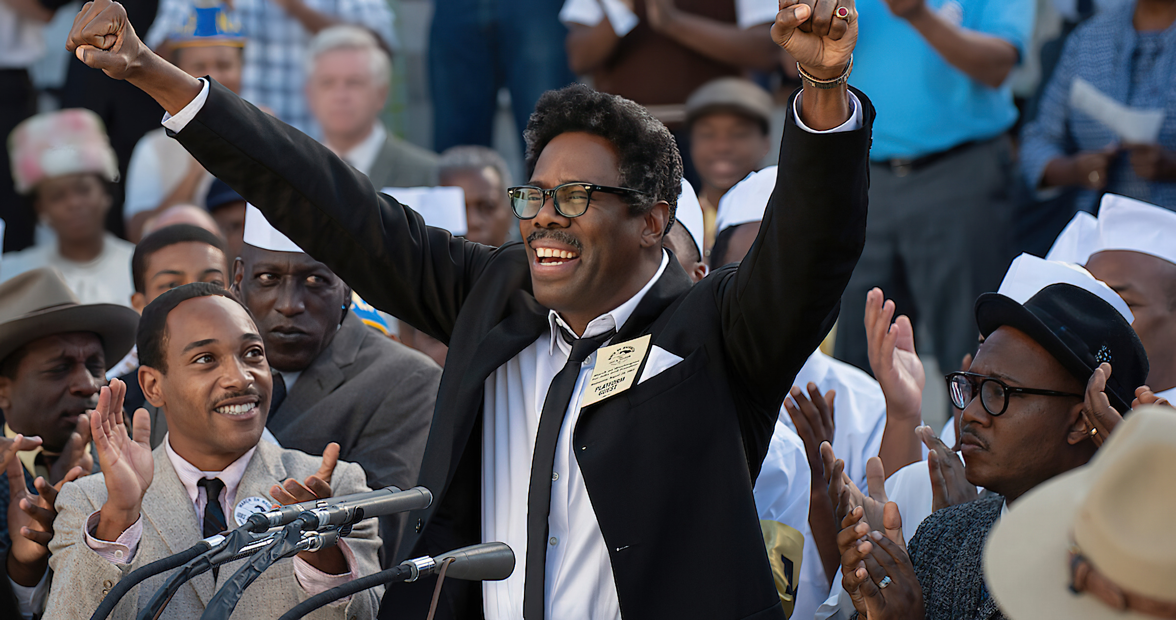 Rustin giving a speech and cheering